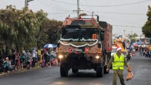 Military truck in festive Australian street parade.
