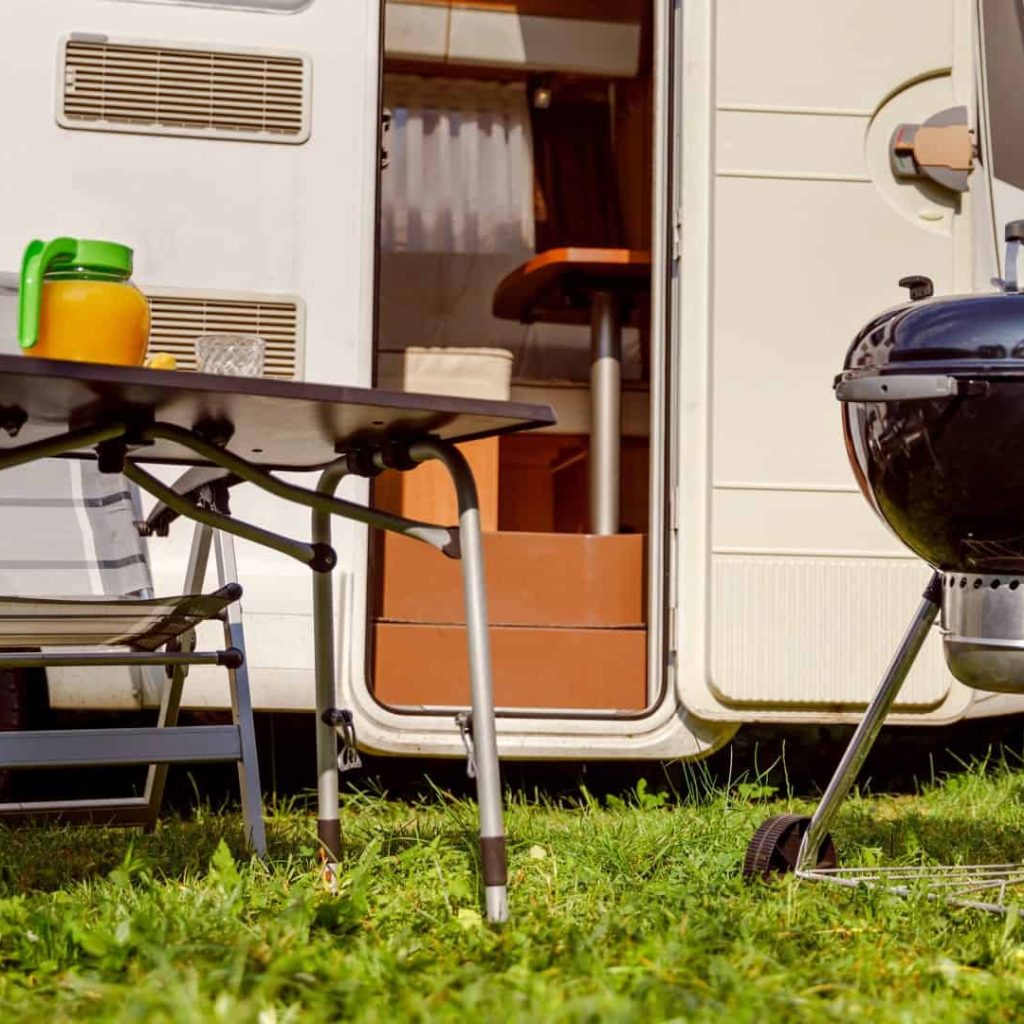 Caravan camping setup with BBQ and bikes in Australia.
