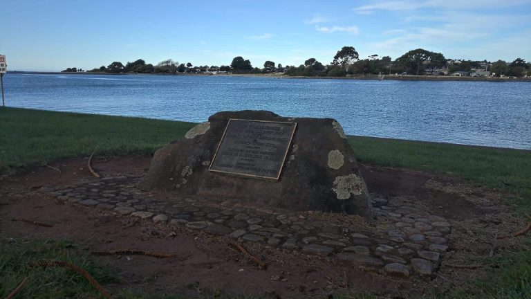 Historic commemorative plaque by a river in Australia.