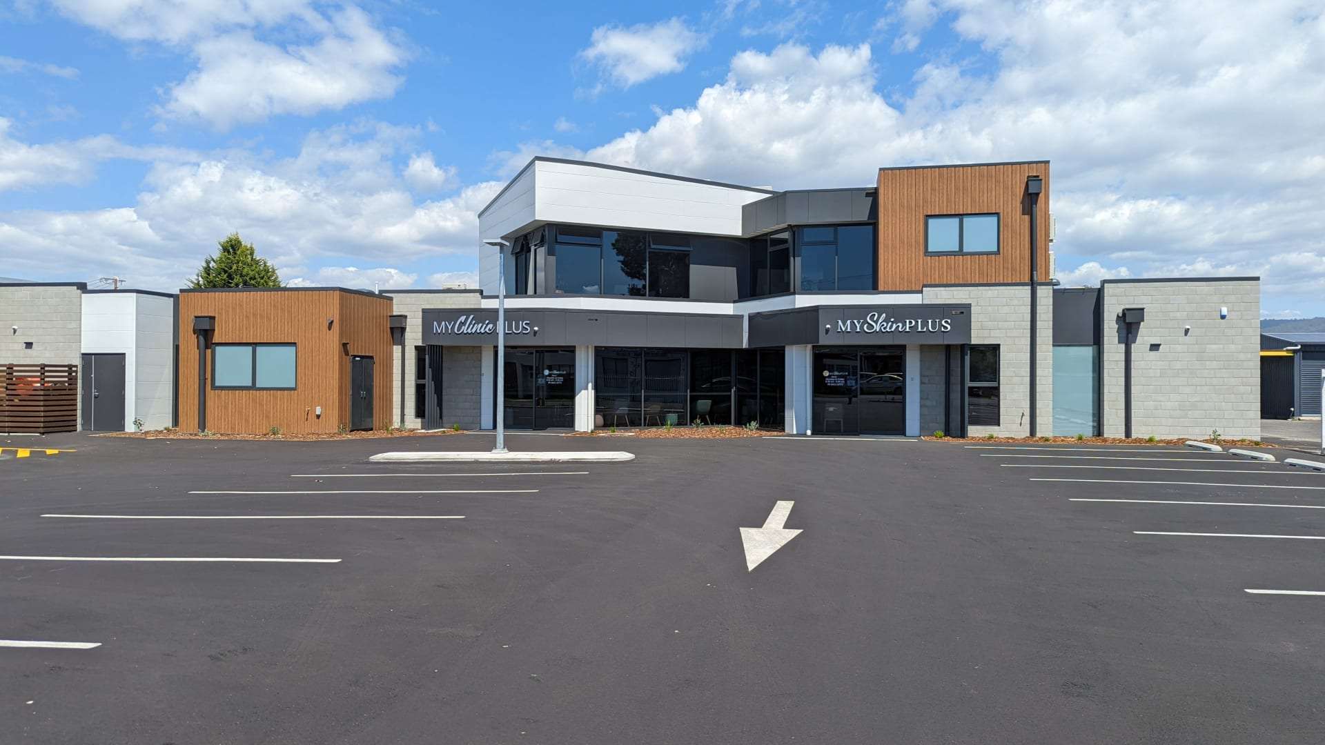 Modern clinic exterior with parking, Australia.