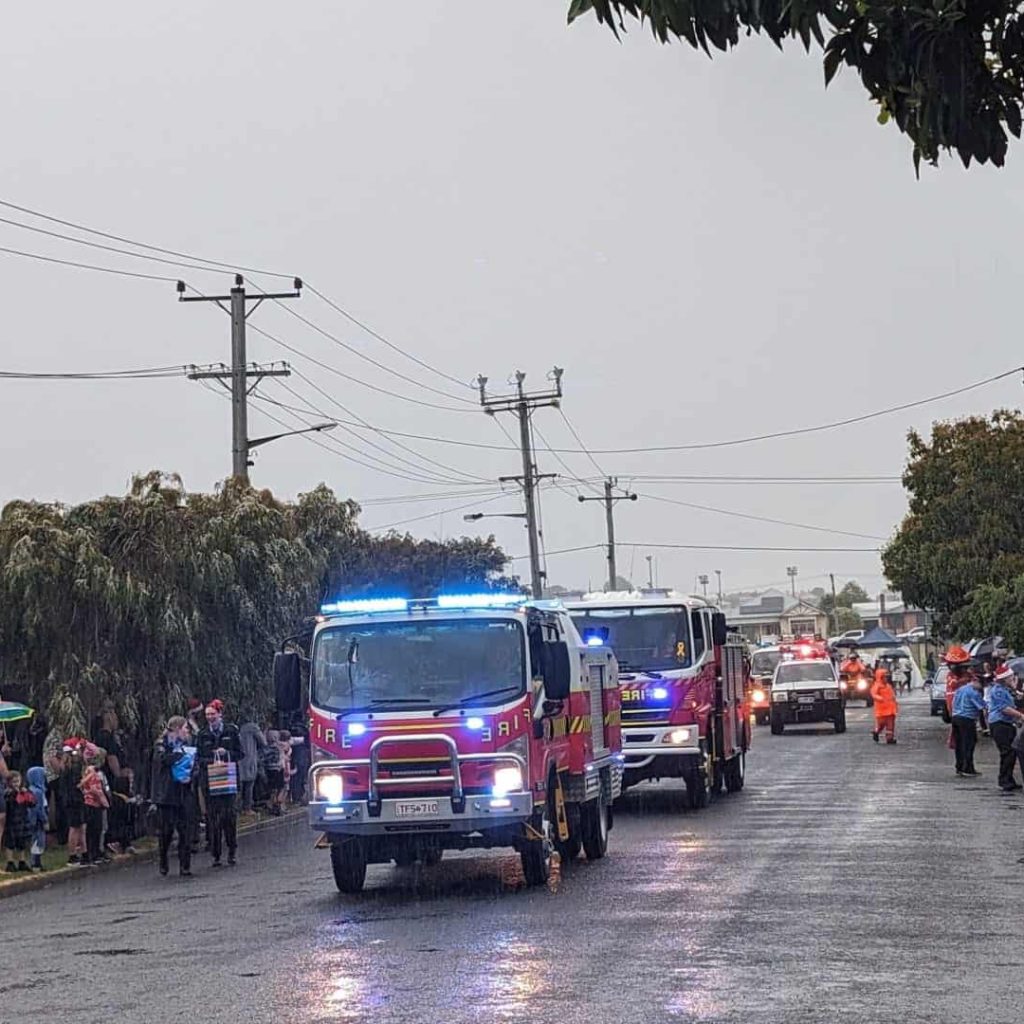 Rainy day with fire trucks and onlookers in Australia.