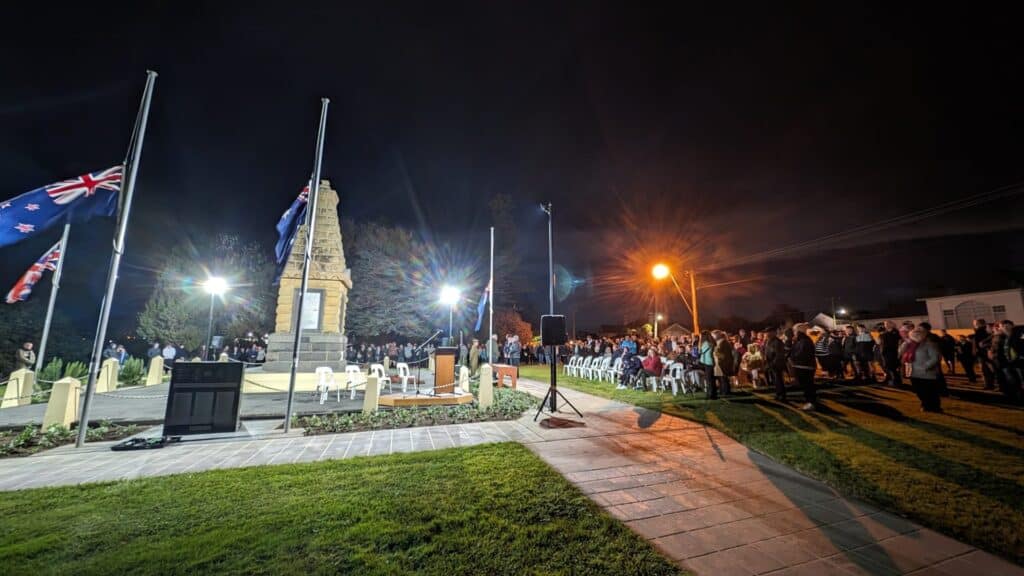 Nighttime Anzac Day service at Australian war memorial.